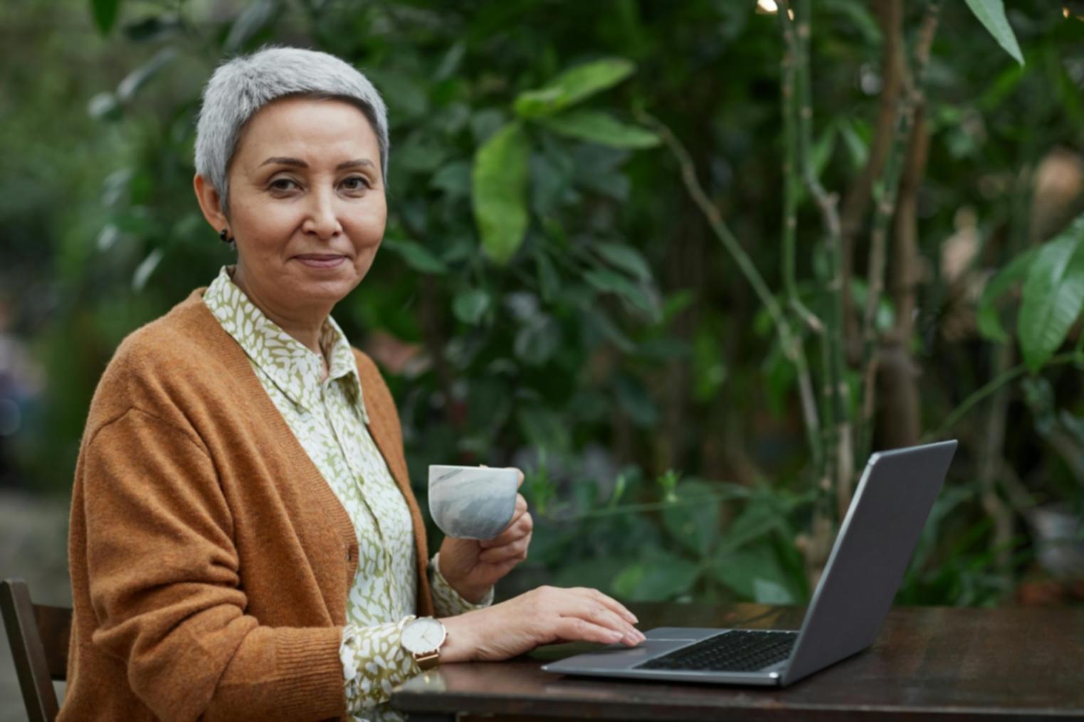 Caregiver helping client with mobility exercises in well-lit therapy space